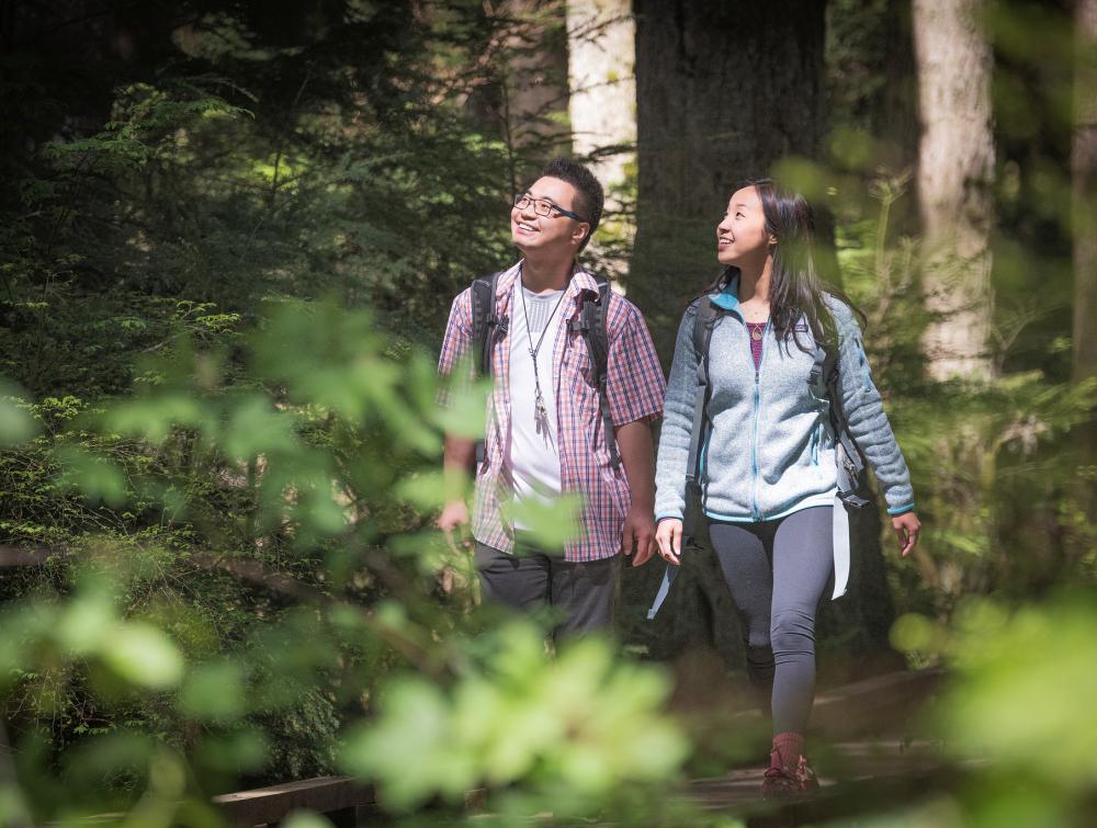 WA_KingCounty_MasonCummings_190501_103-X4 2 smiling people hiking in the woods