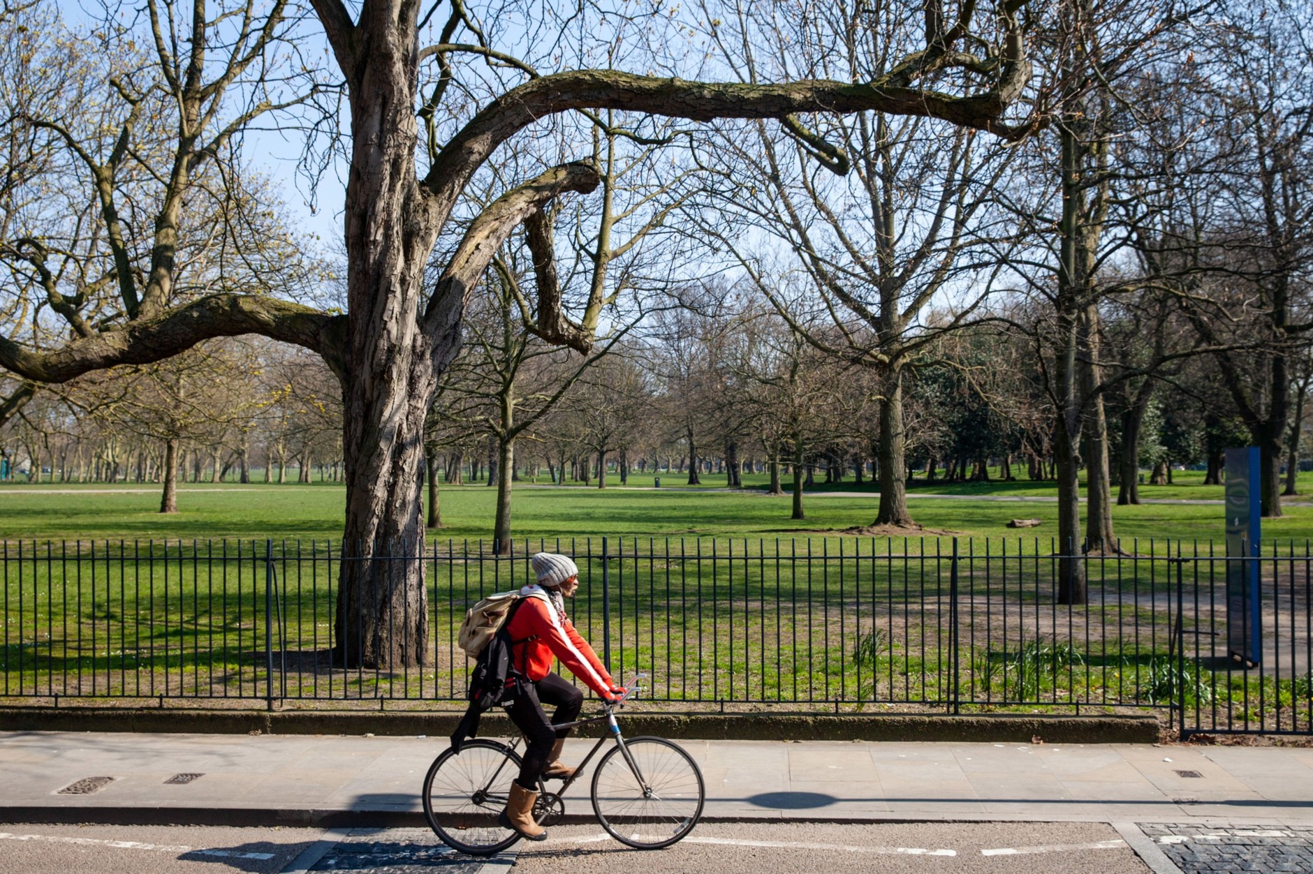 original Person biking next to a park