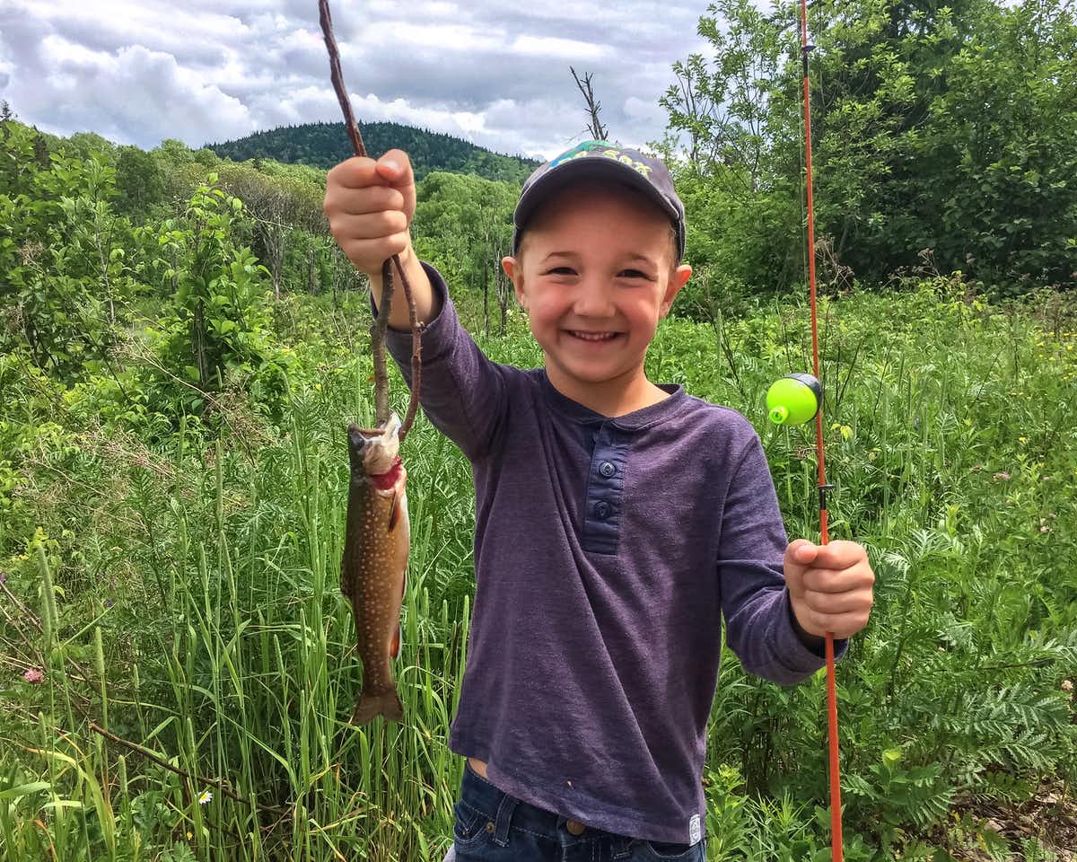 file-20190524-187153-1rnipof young smiling child holding up fish